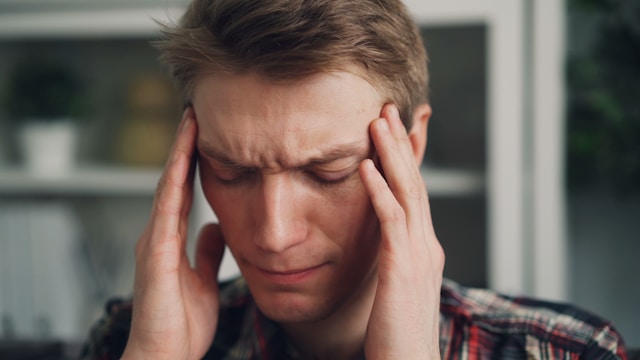 Photo of a male with a migraine