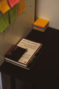 Photo showing a pile of books. The title of the top book reads: "Life lessons of the masters"