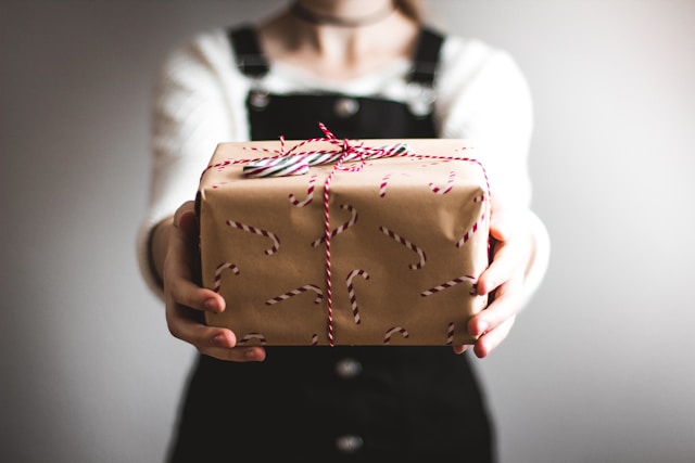 Photo of a woman holding a gift wrapper in paper