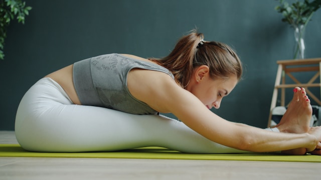 Photo of a woman stretching het body forward