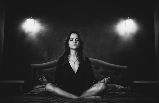 Black and white photo of a woman in meditation.